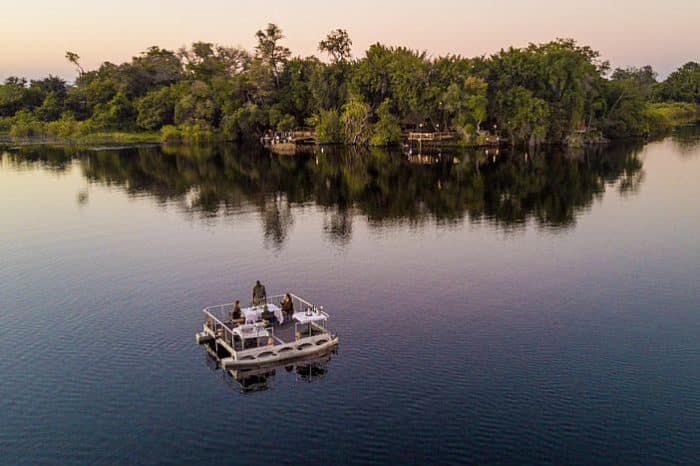 Permanent Water-based camps in Okavango delta, barge dinner in the river